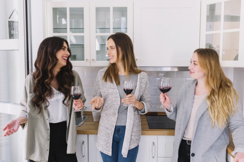 Friends drinking and chatting in the kitchen