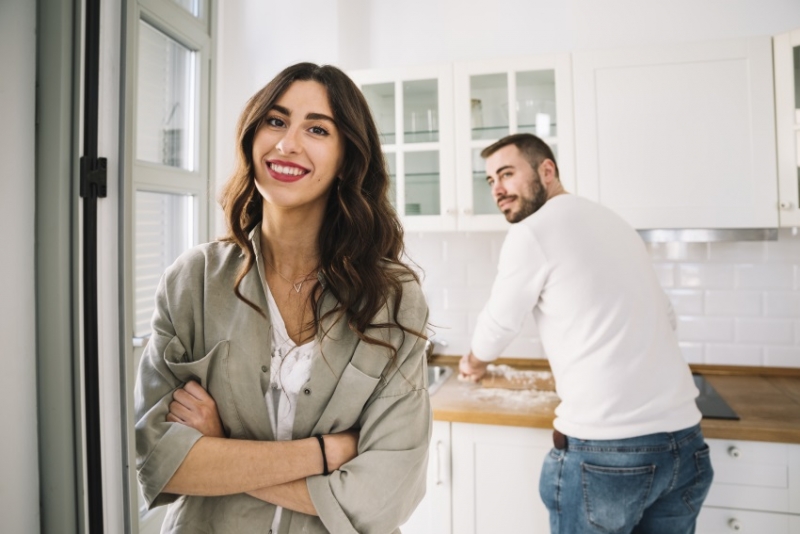 Man and woman in the kitchen cooking.