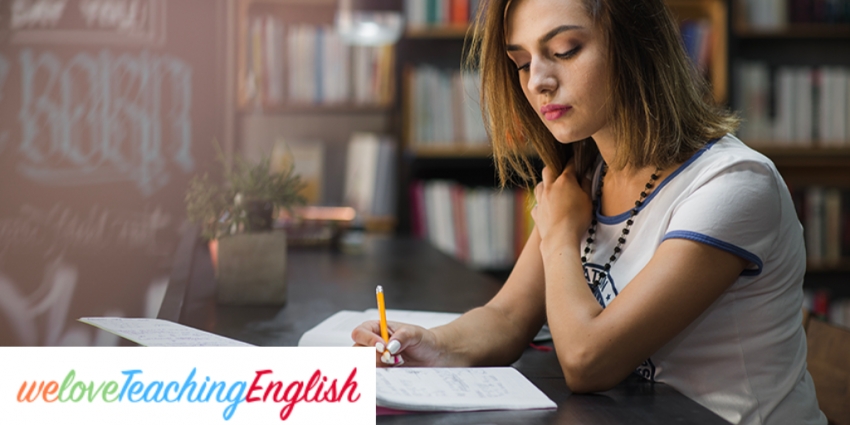 Girl sitting at table with notebook