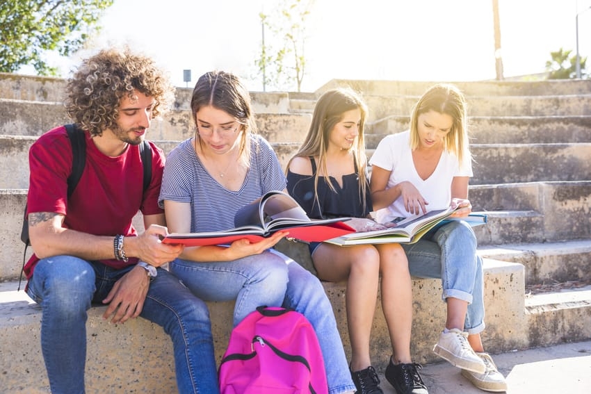 Students sitting and studying on steps